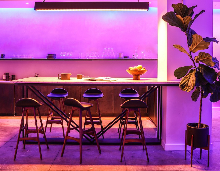 Kitchen island area featuring colorful Ketra fixtures set to an Entertainment/Party scene