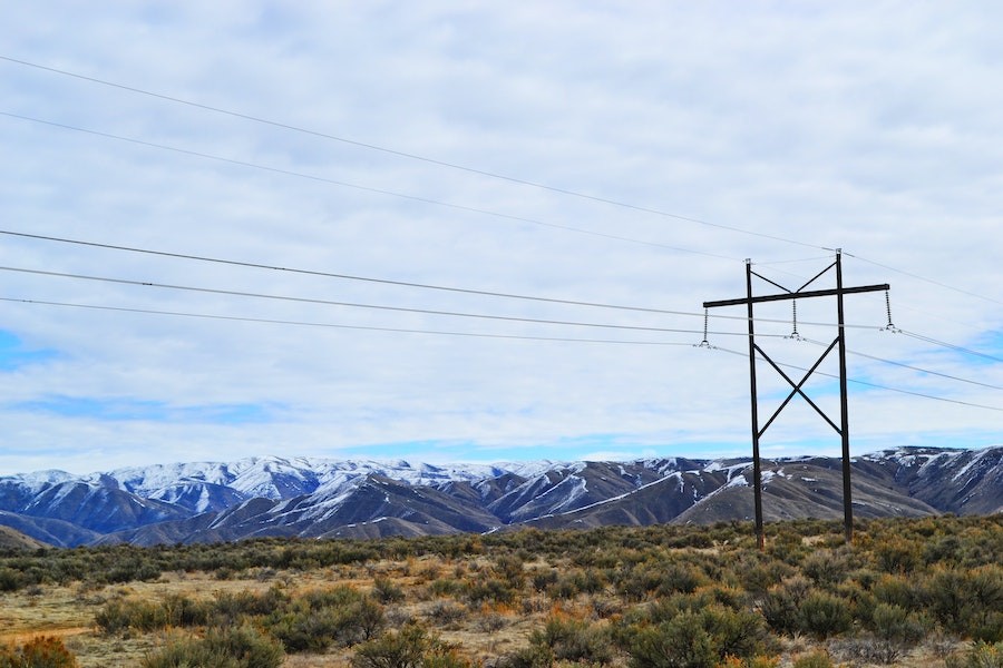 Power lines run through the mountains delivering energy to homes.